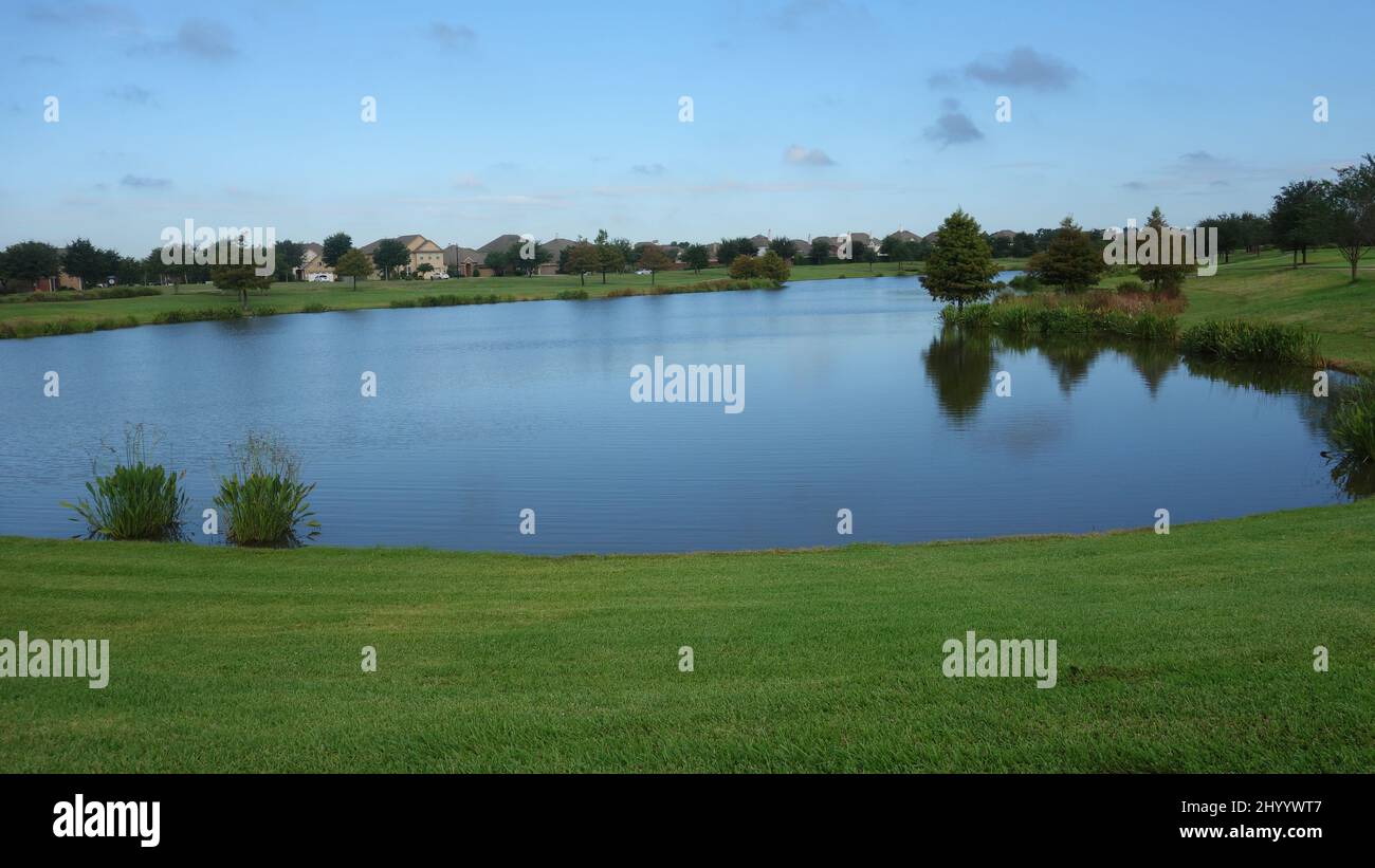 Neighborhood with pond. Blue sky Stock Photo Alamy