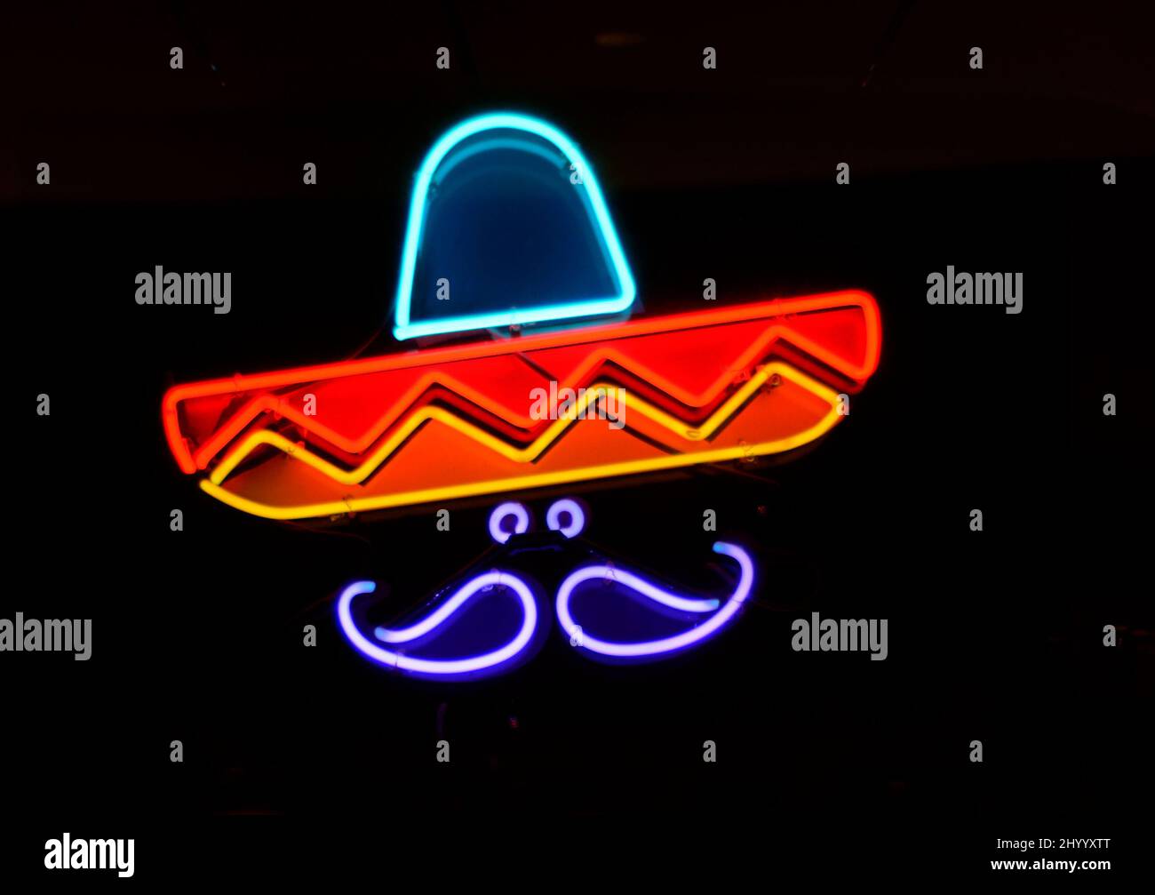 A neon sign with the word 'señor' and the likeness of a Mexican man wearing a sombrero burns in the window of a candy store in Santa Fe, New Mexico. Stock Photo