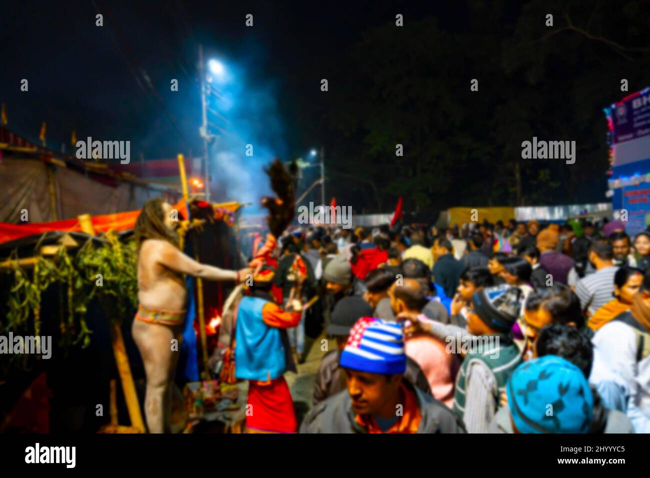 Blurred image of Kolkata, West Bengal, India. Hindu Sadhu blessing devotees at Gangasagar transit camp, Outtram ghat. Huge number of devotees gather i Stock Photo