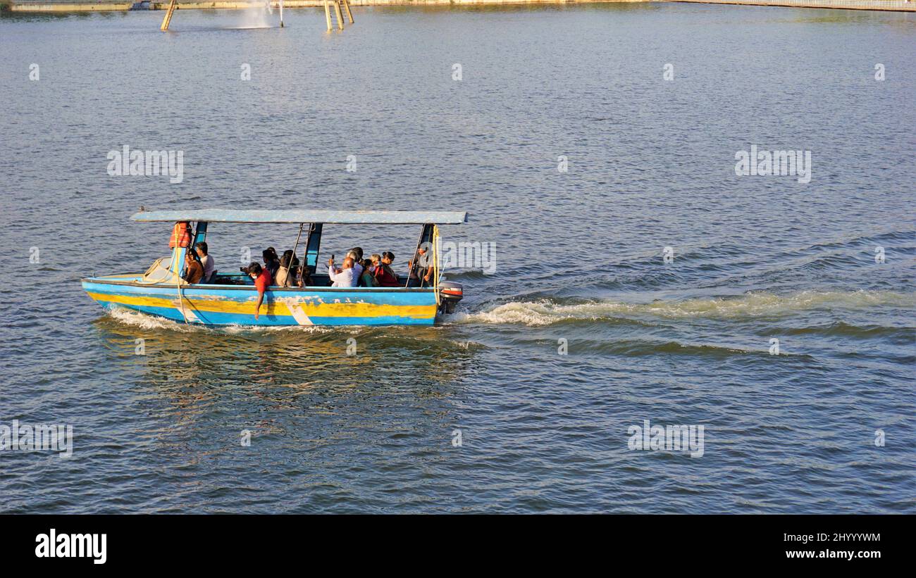 Mysore,Karnataka,India-February 12 2022: Tourists enjoying boat trip around fountain in KRS dam or Brindavan Gardens managed by Mayura Cauvery Boat Cl Stock Photo