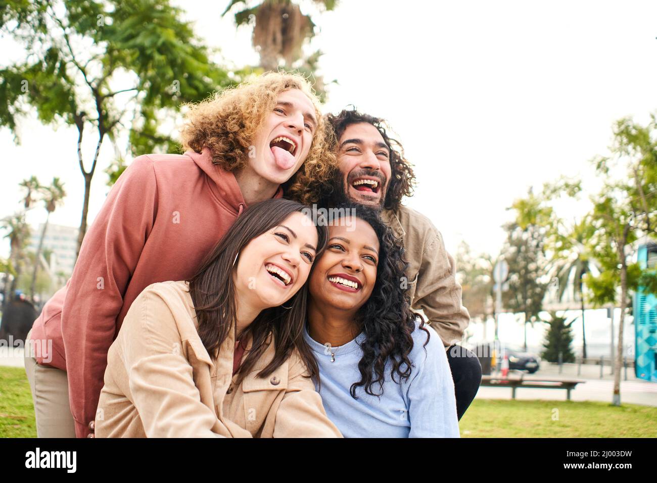 Happy friends from diverse cultures and races taking photo making funny faces - Youth, millennial generation and friendship concept Stock Photo