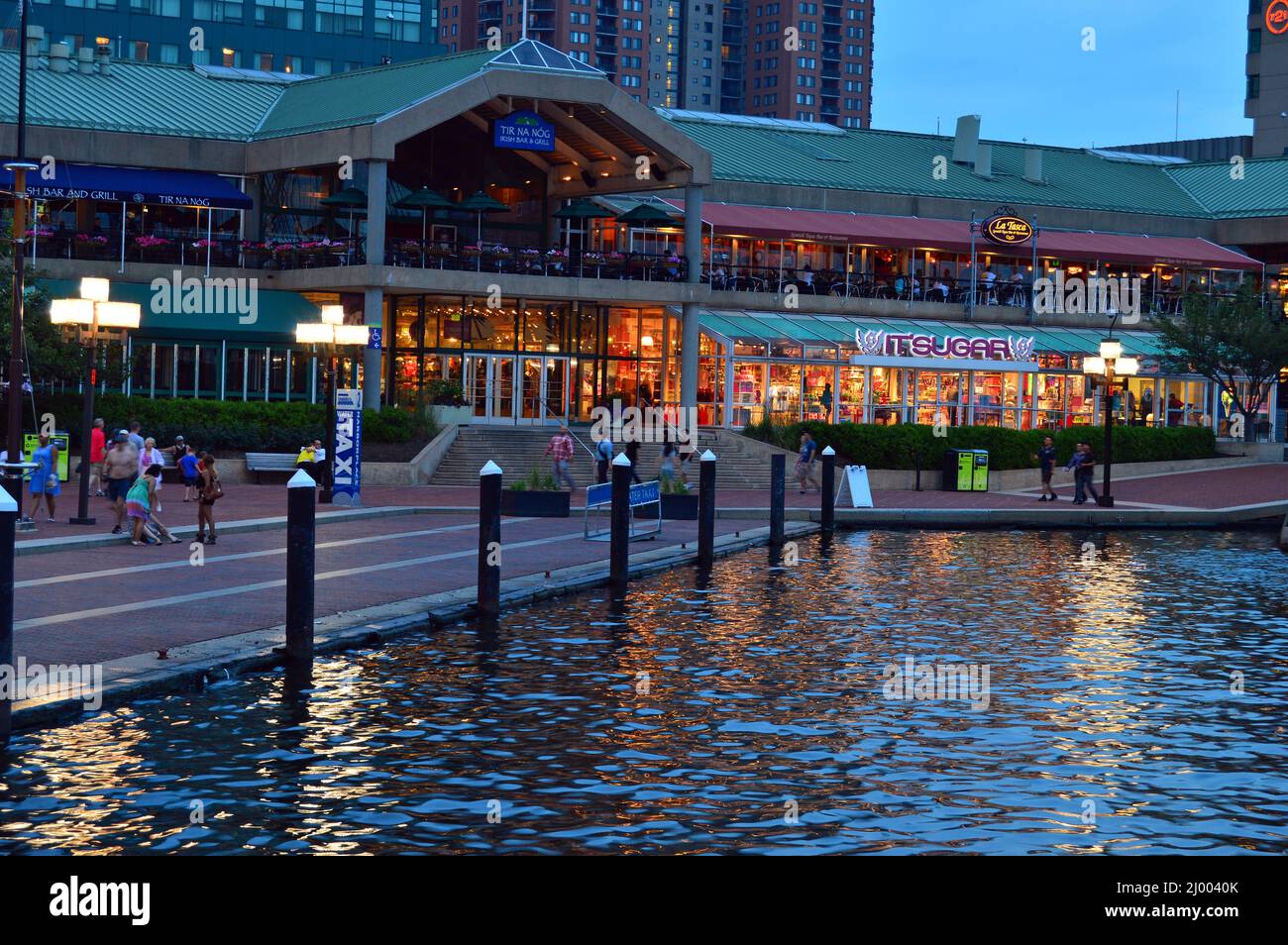 The lights begin to take effect during dusk on Baltimore's Inner Harbor Stock Photo