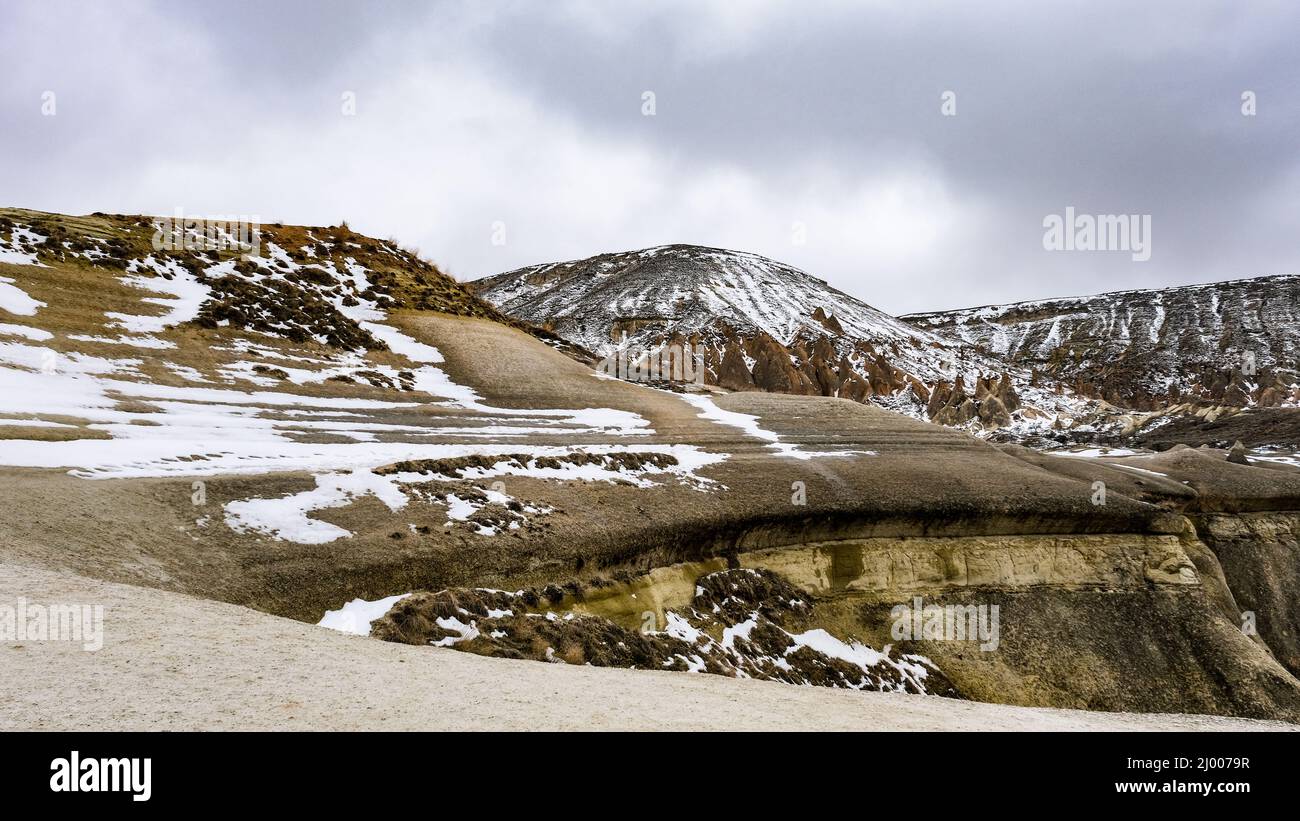 Huge geological formations covered with snow in Cappadocia, Turkey ...
