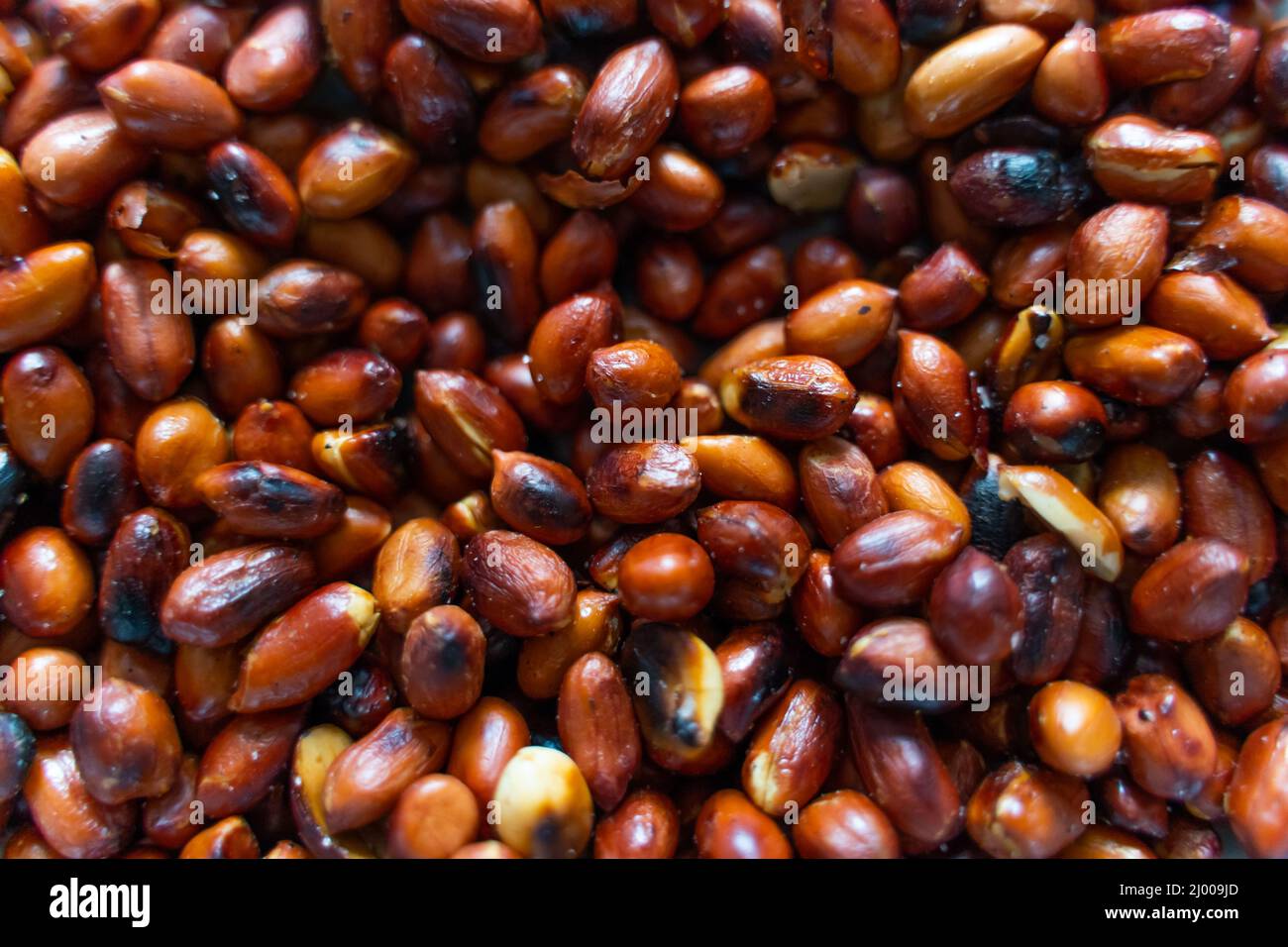 Burnt roasted peanuts in shell closeup Stock Photo Alamy
