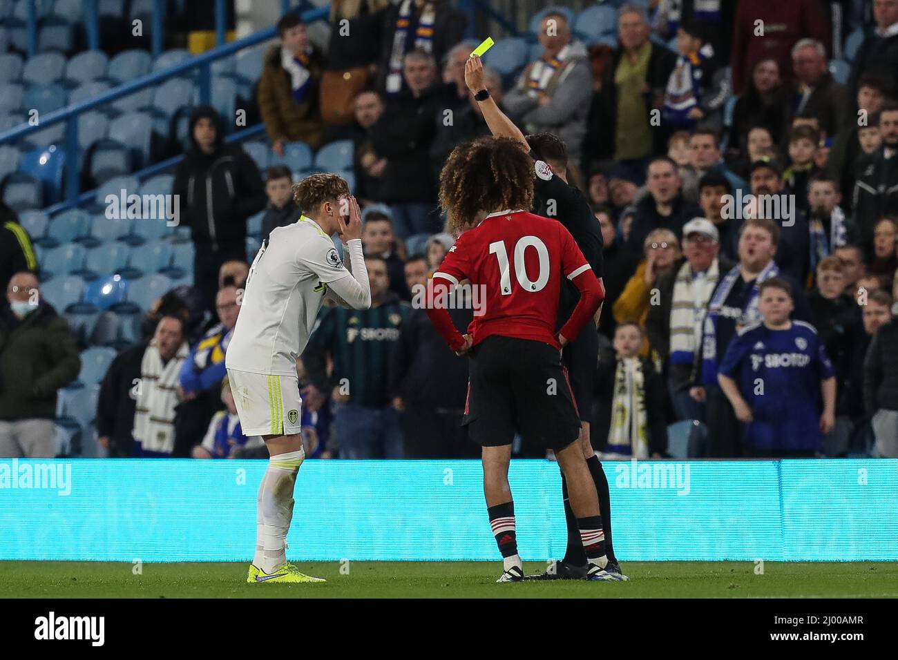 Leeds, UK. 15th Mar, 2022. Referee Thomas Kirk awards a yellow card to Lewis Bate #26 of Leeds United during the first half in Leeds, United Kingdom on 3/15/2022. (Photo by James Heaton/News Images/Sipa USA) Credit: Sipa USA/Alamy Live News Stock Photo