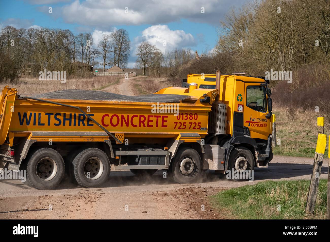 Wiltshire Concrete bright yellow Renault C430 Truck 8x4 with Abba tipping body in motion on a country lane Stock Photo