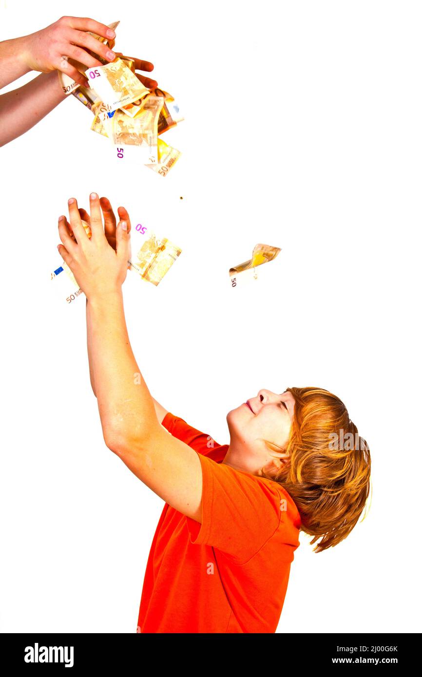 Euros flying around a boys head Stock Photo