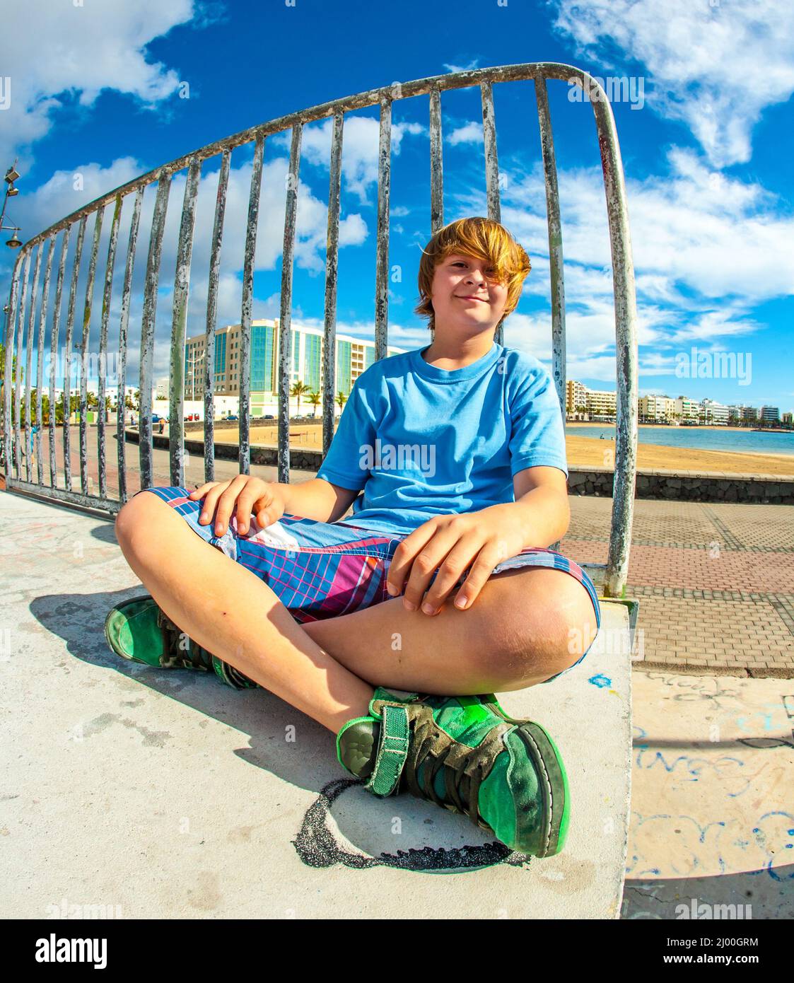 Boys Ramp cute boy is sitting on a ramp at the skate park and smiles Stock Photo ...