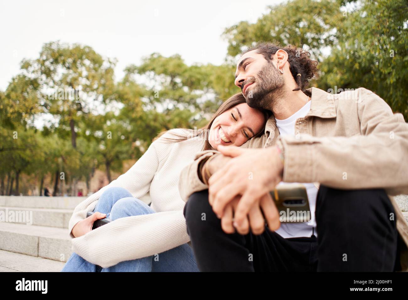 Caucasian young couple in love having fun together outdoors in the park of the city. Stock Photo