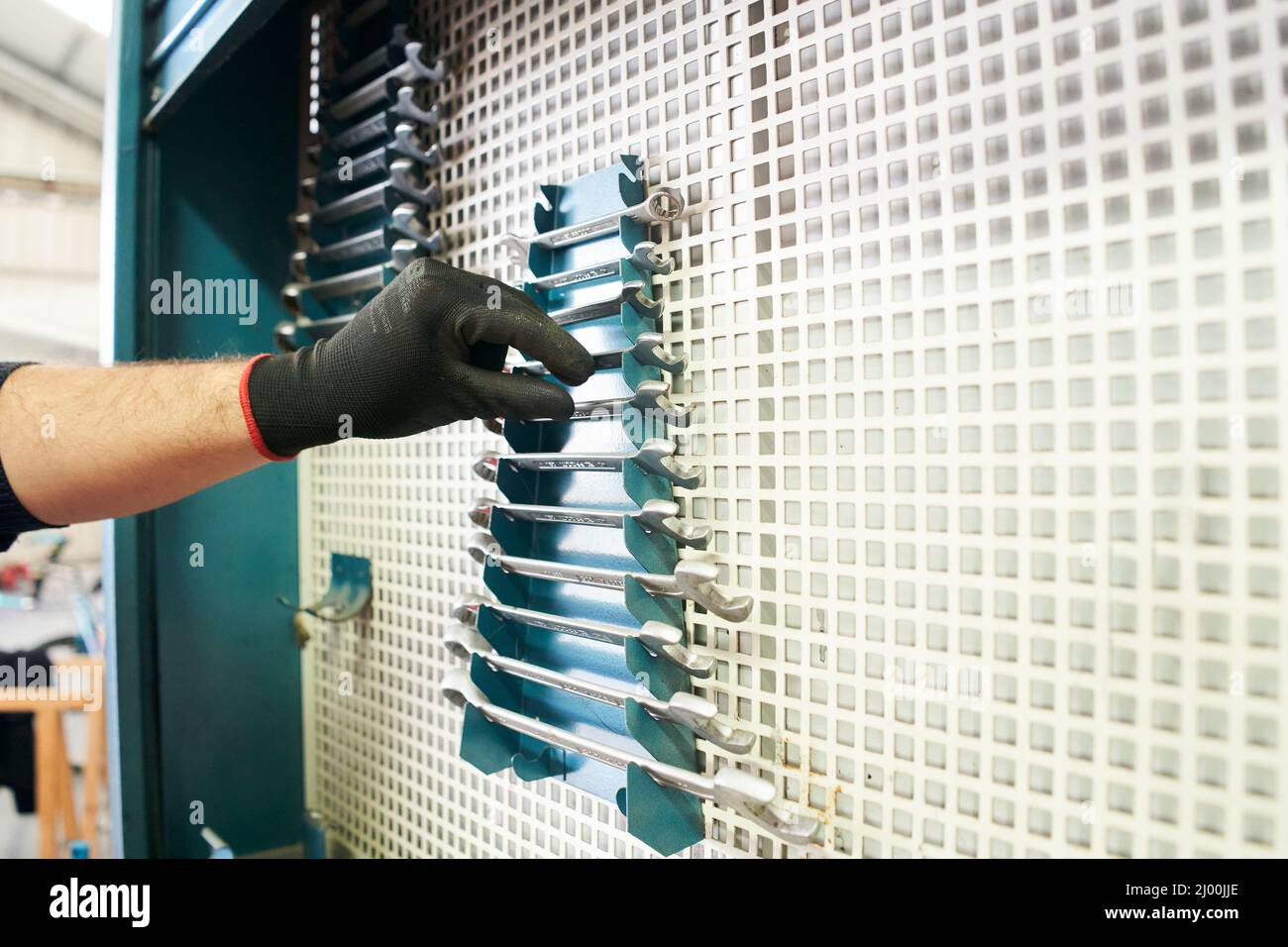 Mechanic getting wrenches from metal toolbox, close-up. Stock Photo