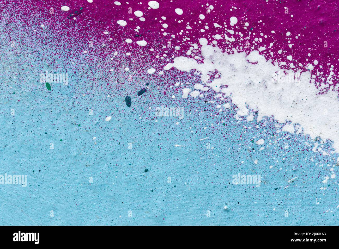 Macro close-up of light blue, purple and white spray paint with