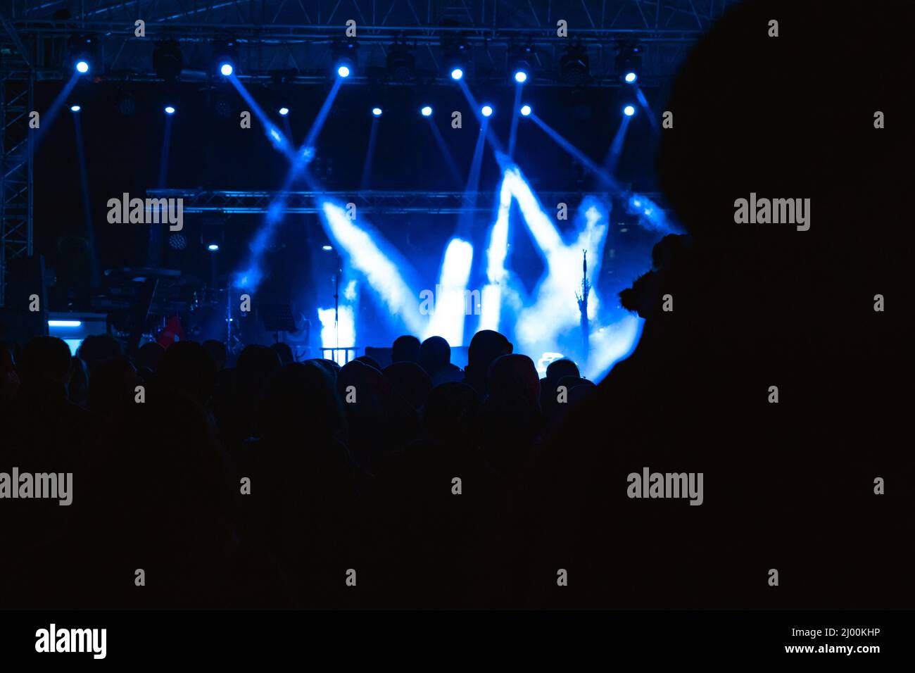Celebration or event or concert background photo with silhouette of people. Noise included. Stock Photo