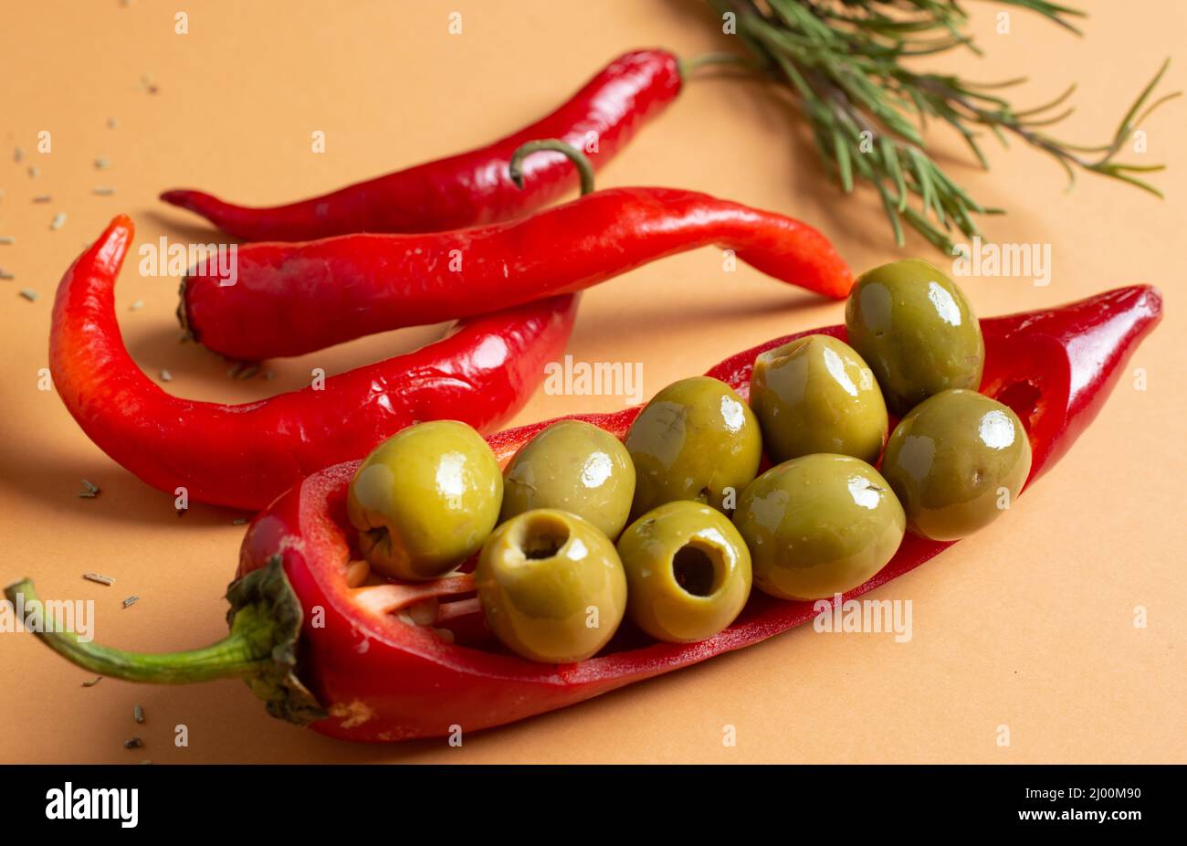 Still life composition of green olives, red hot chilly and spices Stock
