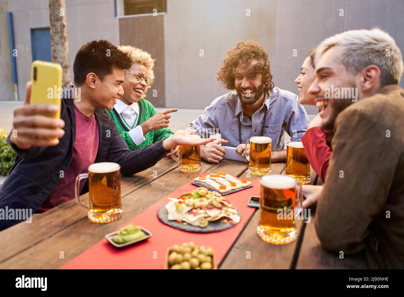 friends taking selfie and drinking beer at bar Stock Photo