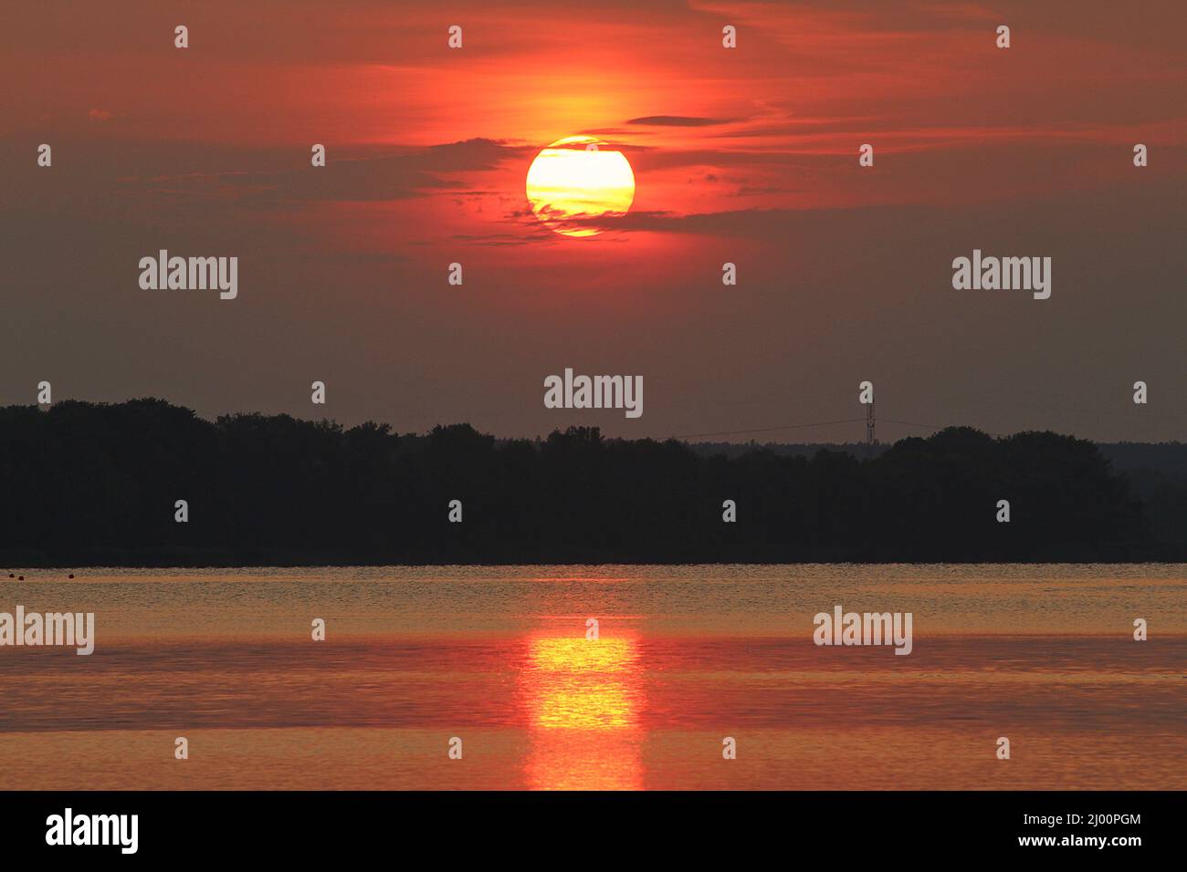 Scenic landscape with a lake during red sunset Stock Photo - Alamy