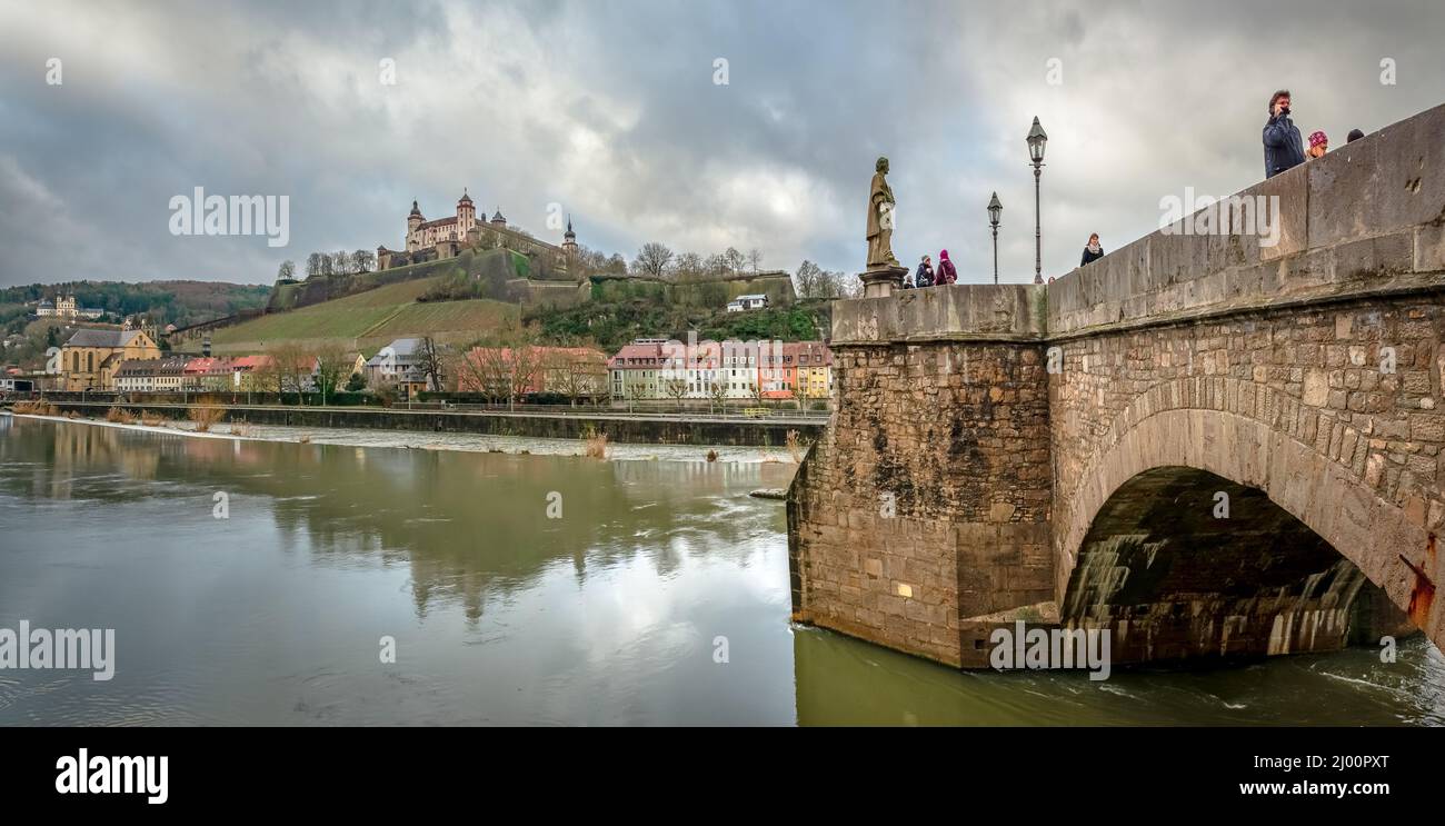 View of the western bank of the river Main that crosses Wurzburg, Germany, with Alte Mainbrucke on the left and the Marienberg Fortress. Stock Photo