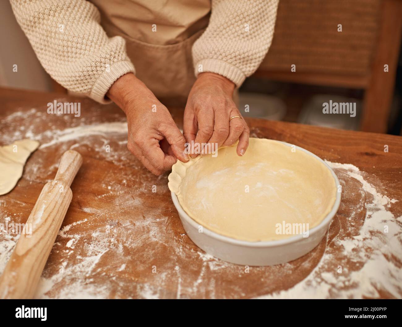 Made with love.... A cropped view of hands working the dough while