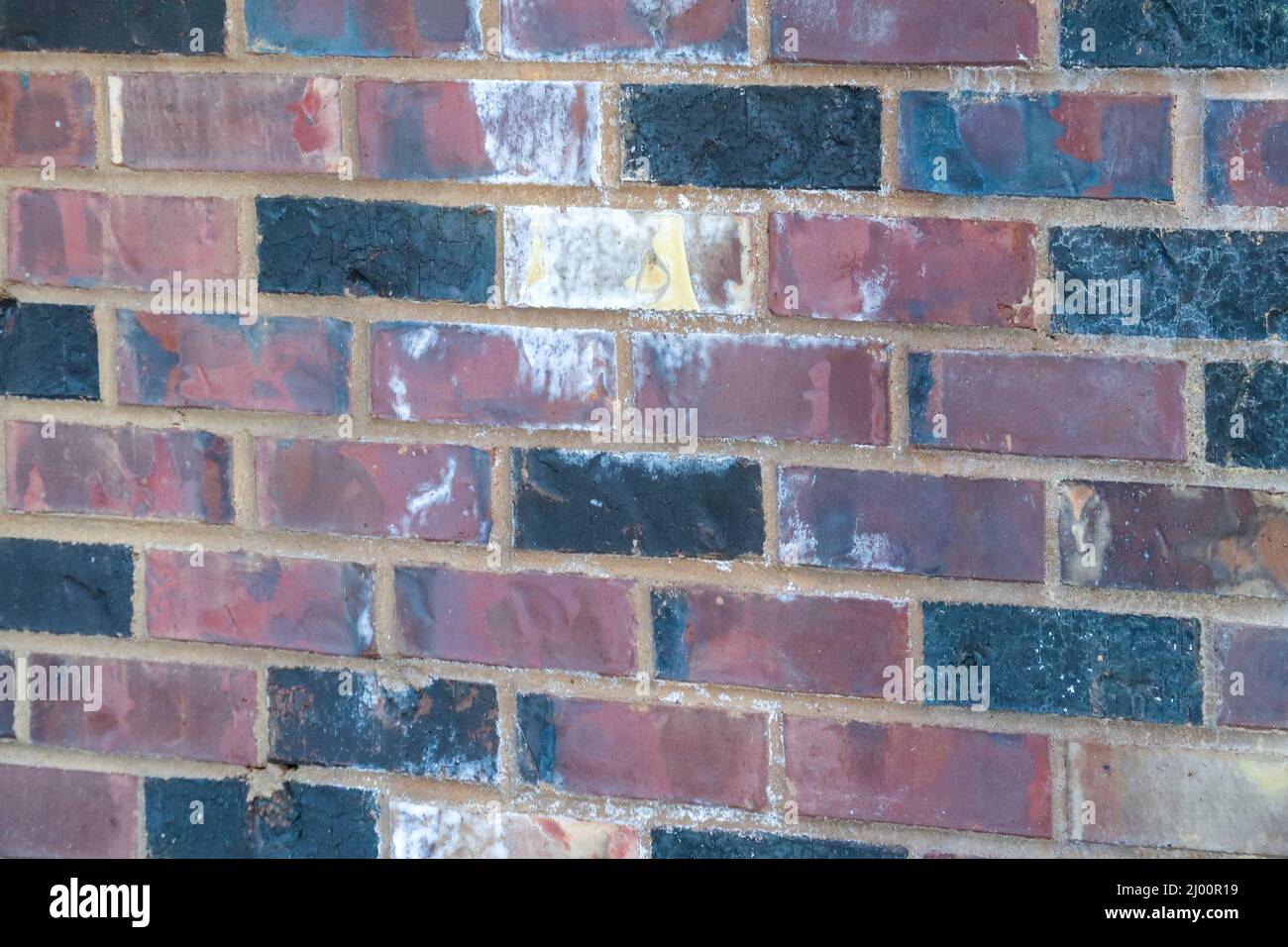 red brick wall with old damaged bricks Stock Photo