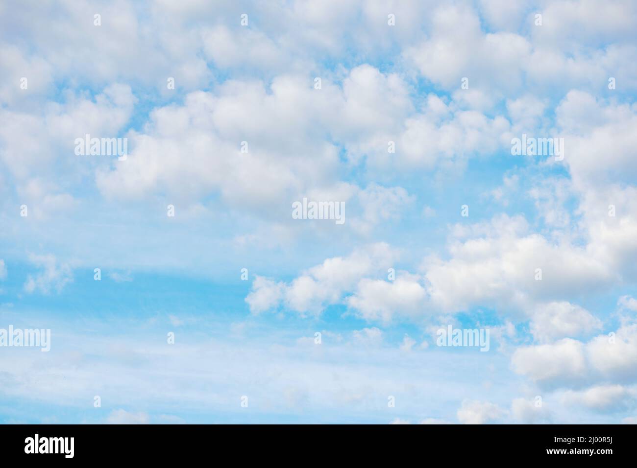 Bright blue sky with scattered white puffy clouds Stock Photo - Alamy