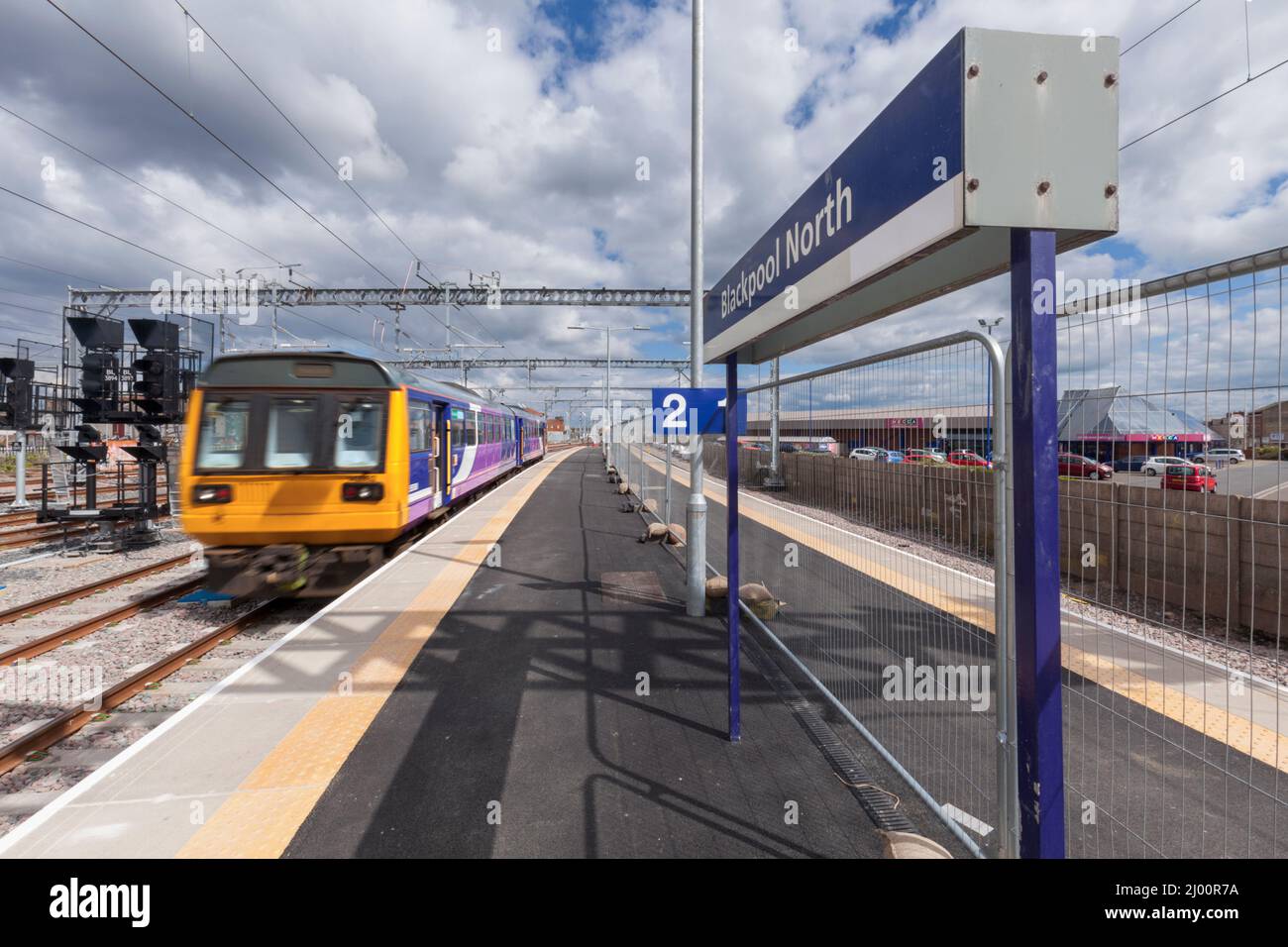 Northern Rail class 142 pacer train 142092 departing from Blackpool North railway station with motion blur and the station sign Stock Photo