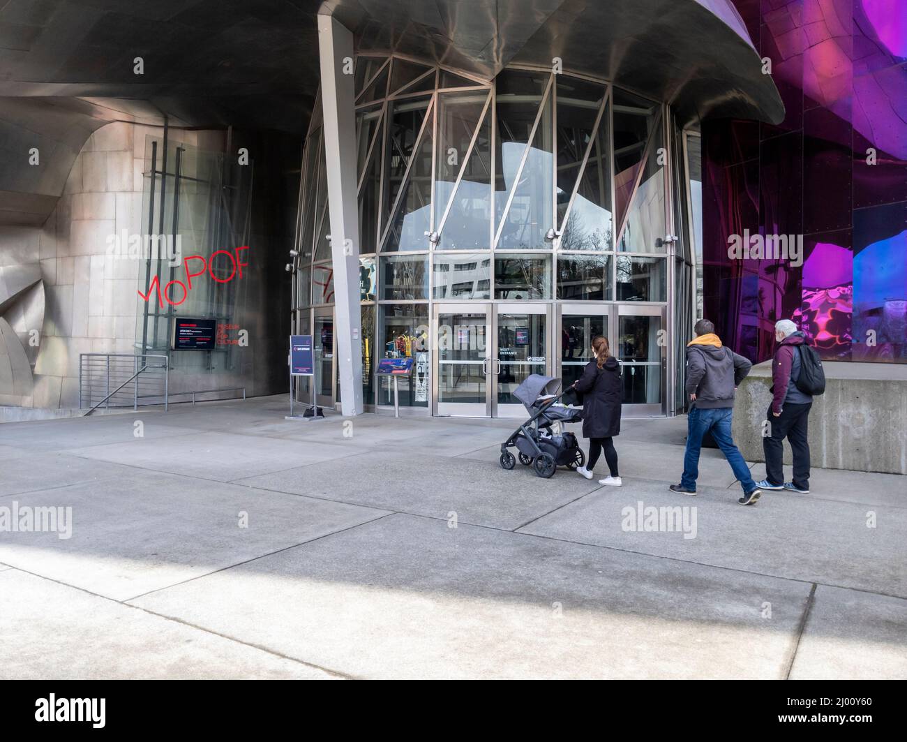 Seattle, WA USA - circa March 2022: Family with a baby stroller entering the Museum of Pop Culture on a bright, sunny day. Stock Photo