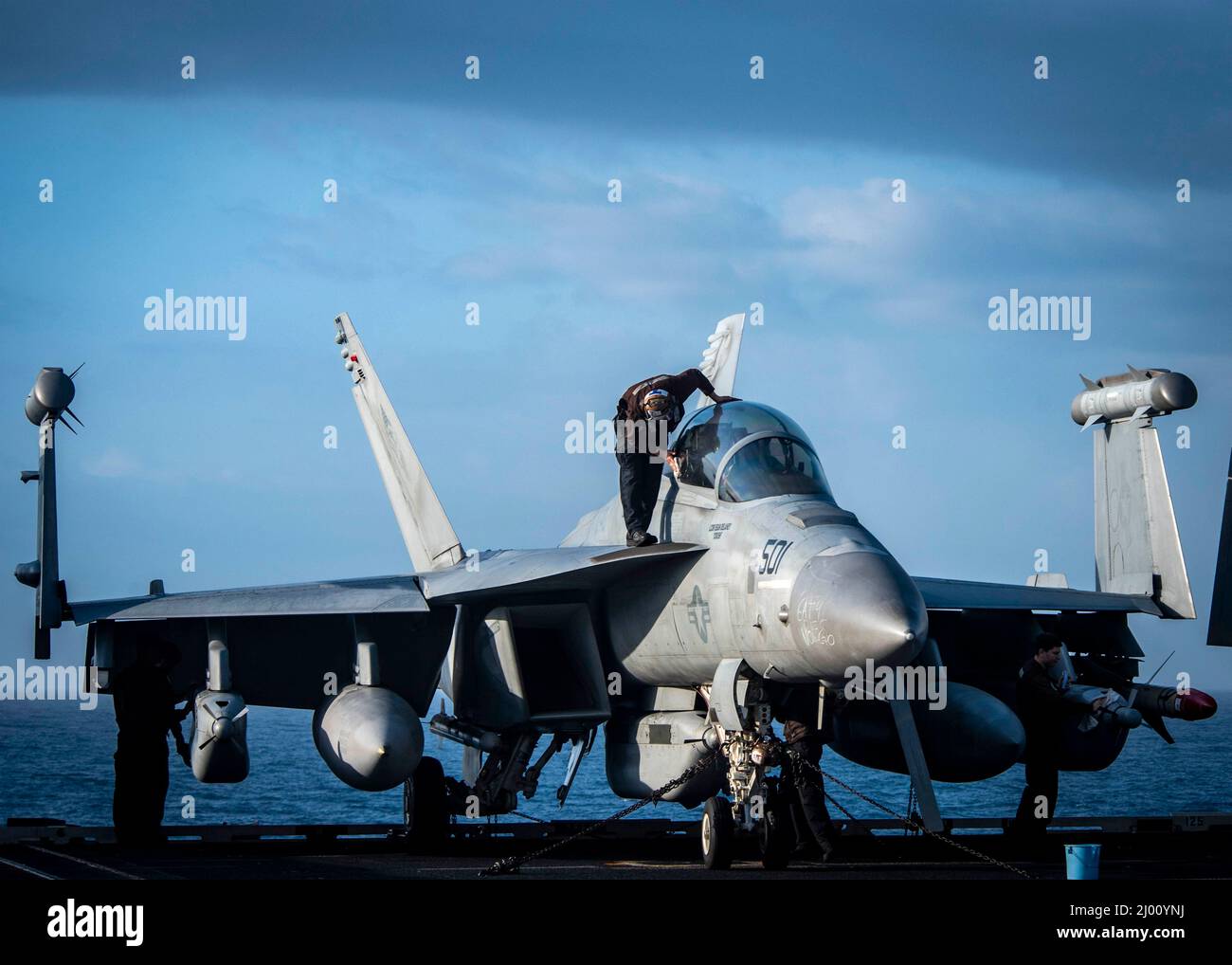 USS George Bush, United States. 12 March, 2022. A U.S. Navy sailor assigned to the Patriots of Electronic Attack Squadron 140, wipes down an E/A-18 G Growler aircraft aboard the Nimitz-class aircraft carrier USS George H.W. Bush, March 6, 2022 in the Atlantic Ocean.  Credit: MC3 Bryan Valek/Planetpix/Alamy Live News Stock Photo