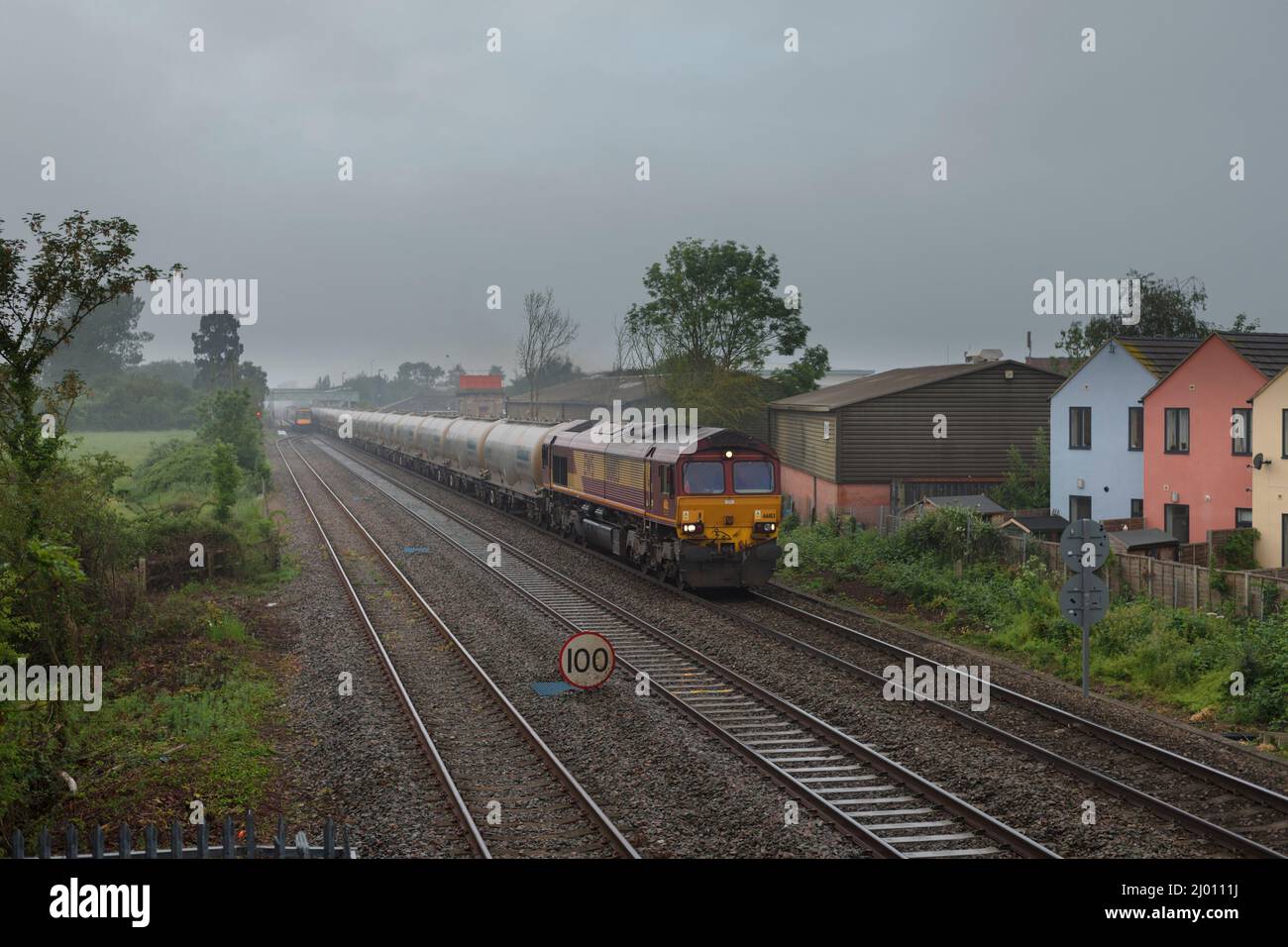DB Cargo rail UK class 66 locomotive 66183 passing Ashchurch for Tewkesbury with a freight train of empty Castle cement tanks Stock Photo