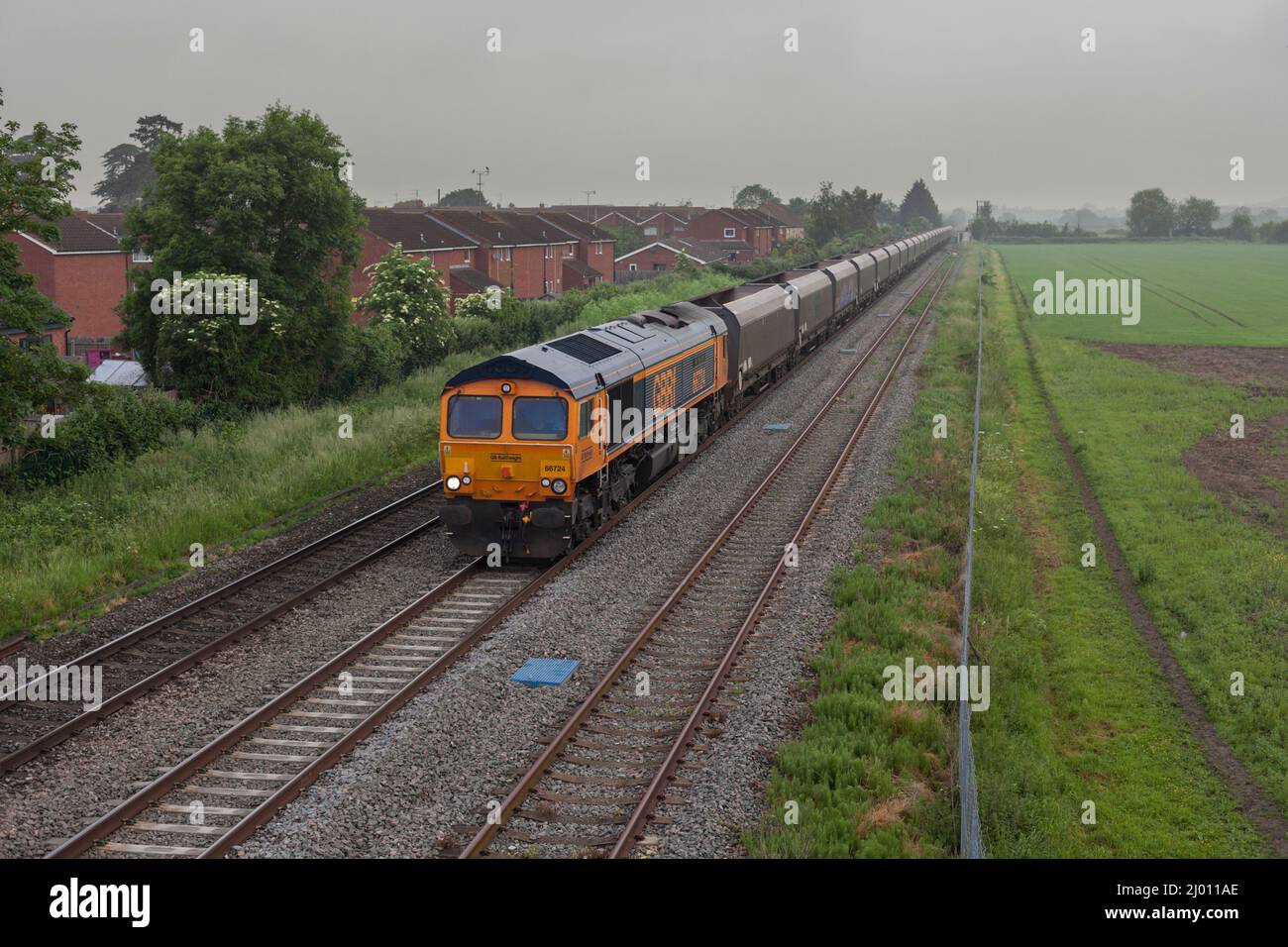 GB Railfreight  class 66 locomotive 66724 passing Ashchurch for Tewkesbury with a freight train of empty coal wagons Stock Photo