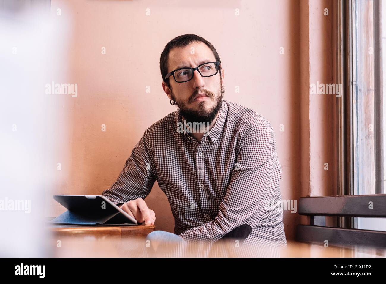 young businessman working on his tablet in a cafe shop Stock Photo
