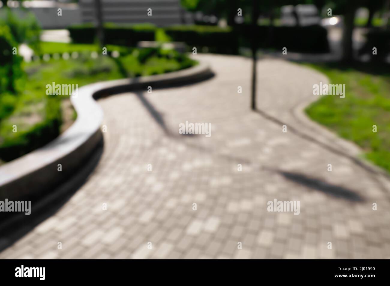 Blurred view of beautiful alley in city park Stock Photo - Alamy