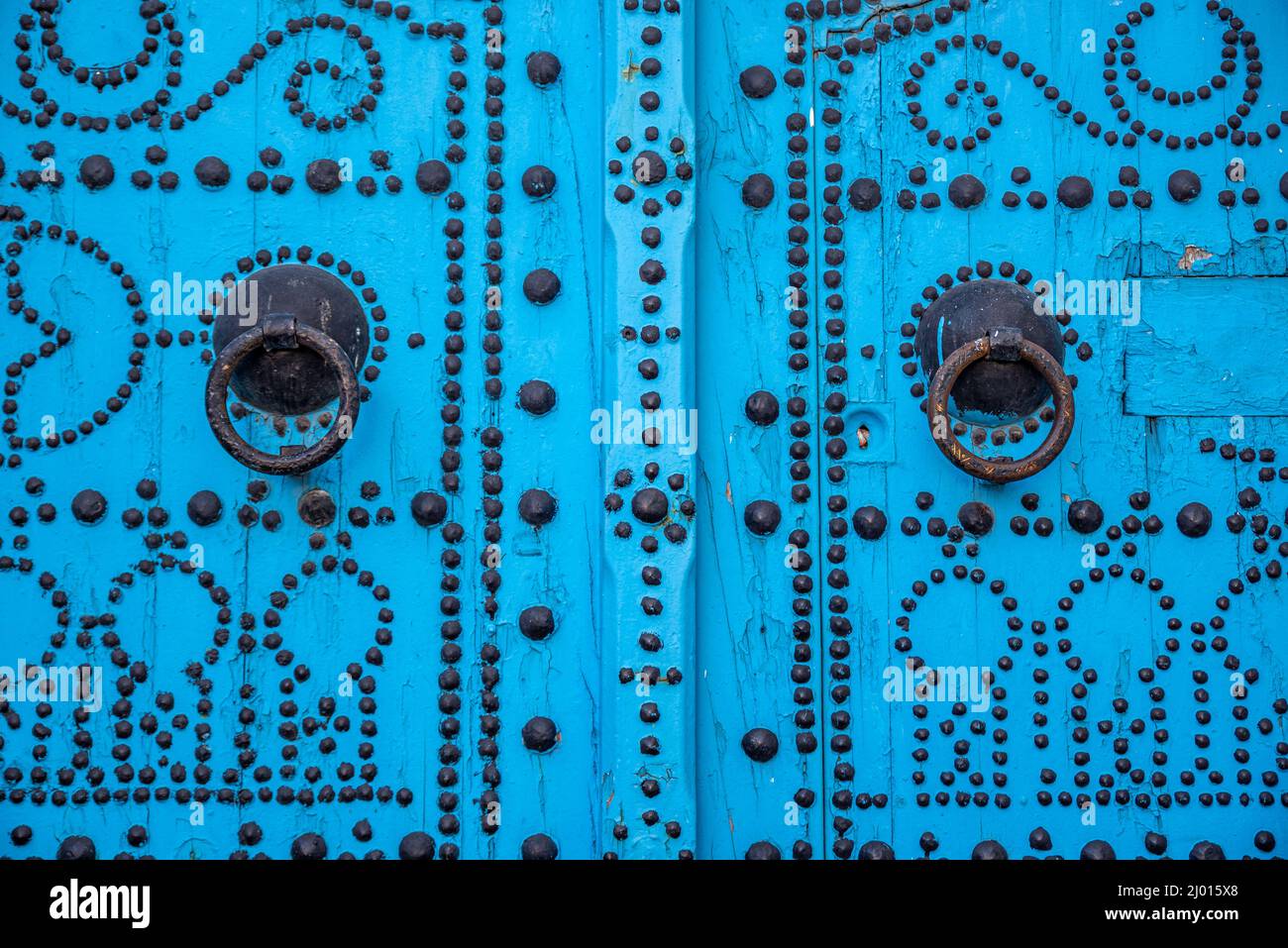 Traditional blue door of an antique house in an alleyway of the medina (old city) of Tunis, Tunisia. Stock Photo