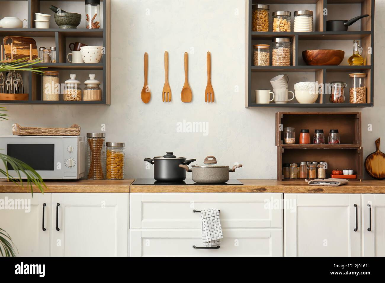 Interior of light modern kitchen with white counters and shelves Stock ...