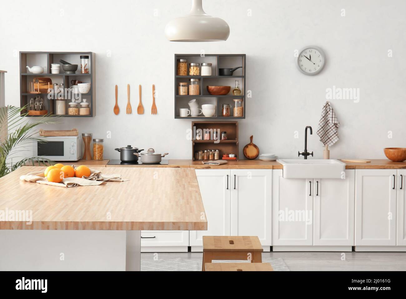 Interior of light modern kitchen with white counters and food Stock ...