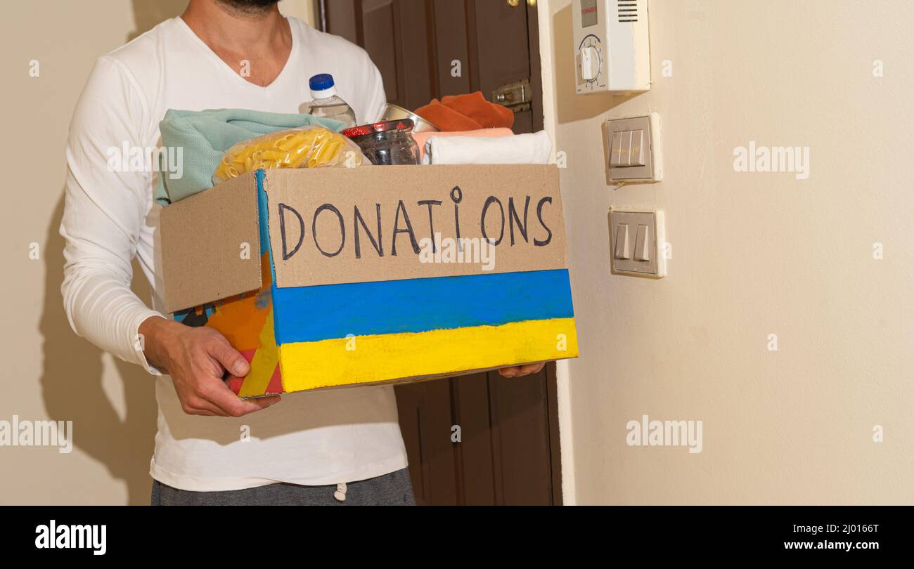 Man giving donation boxes hi-res stock photography and images - Alamy