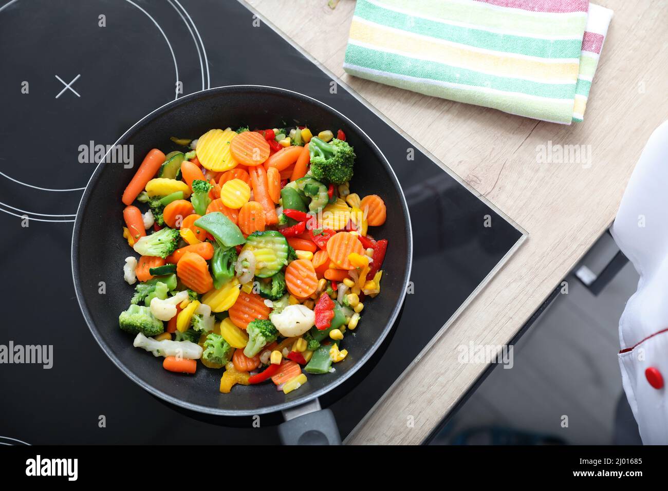 Frying pan with healthy vegetables on stove Stock Photo Alamy