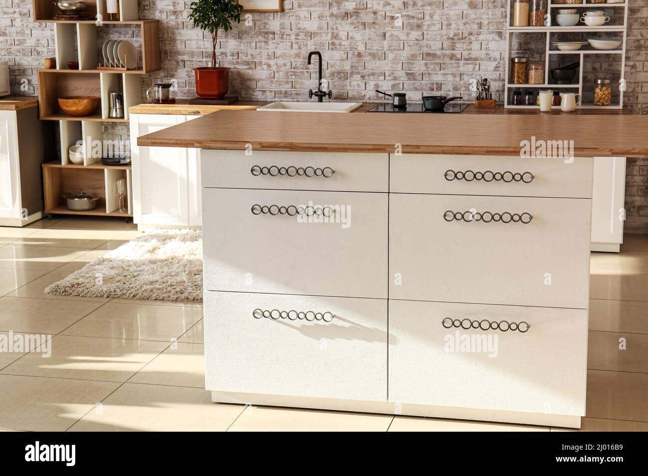 Modern table with drawers in interior of kitchen Stock Photo - Alamy