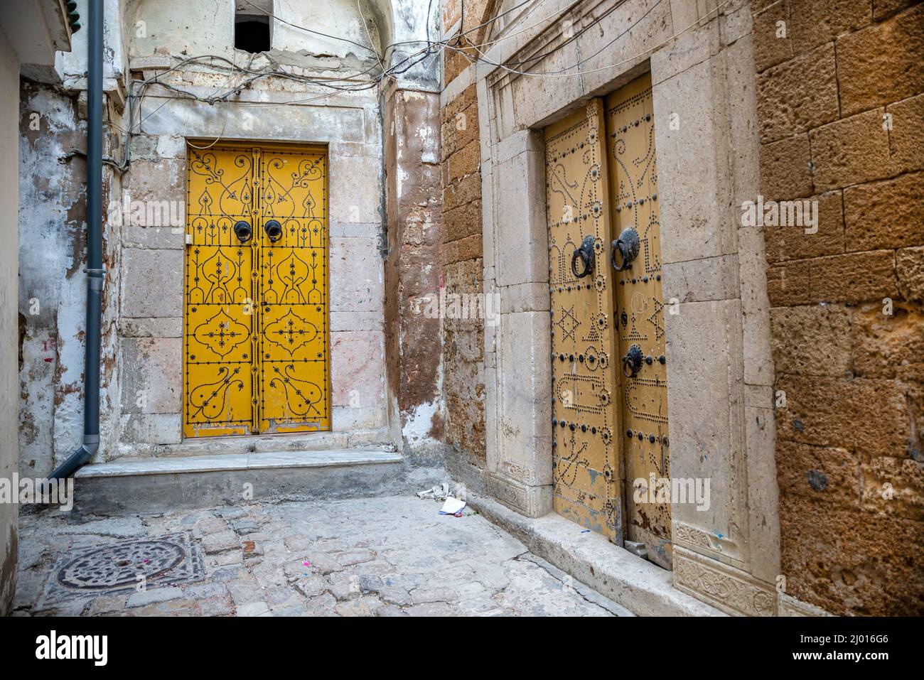 Traditional blue door of an antique house in an alleyway of the medina (old city) of Tunis, Tunisia. Stock Photo