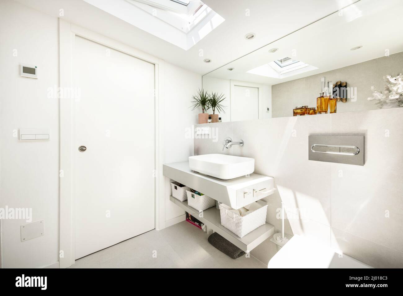 Attic toilet, plants, decorative orange jars, porcelain sink, long