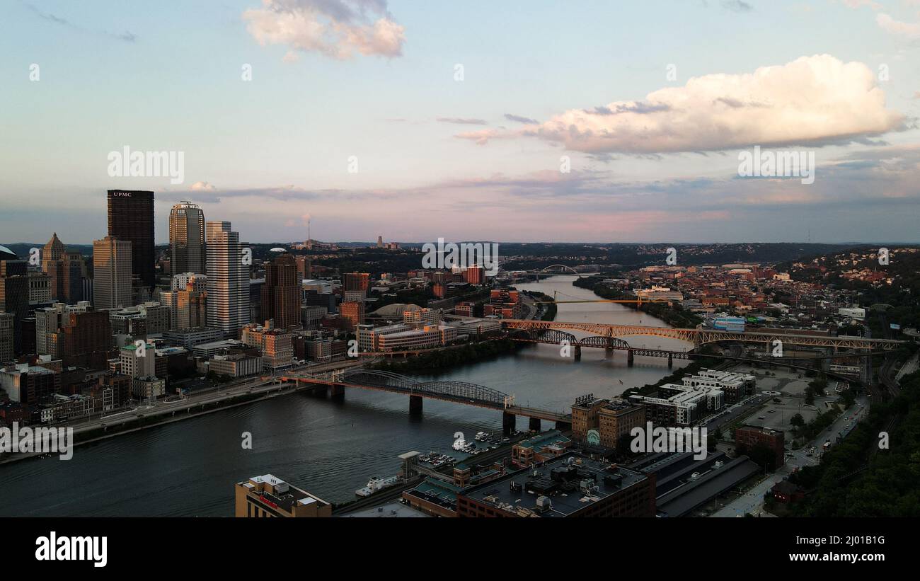 Aerial view of a big city with skyscrapers and a river with bridges in ...