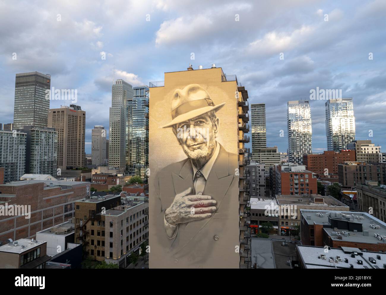 view of the Leonard Cohen mural Painting on a skyscraper in Montreal, Canada with a blue sky