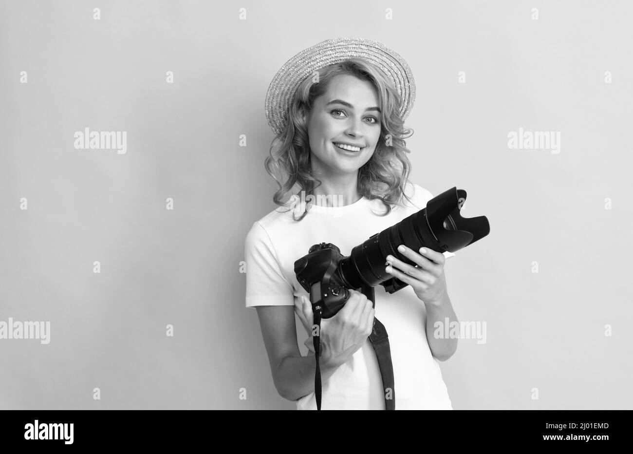 pretty woman photographer with camera in straw hat making photo, photography Stock Photo