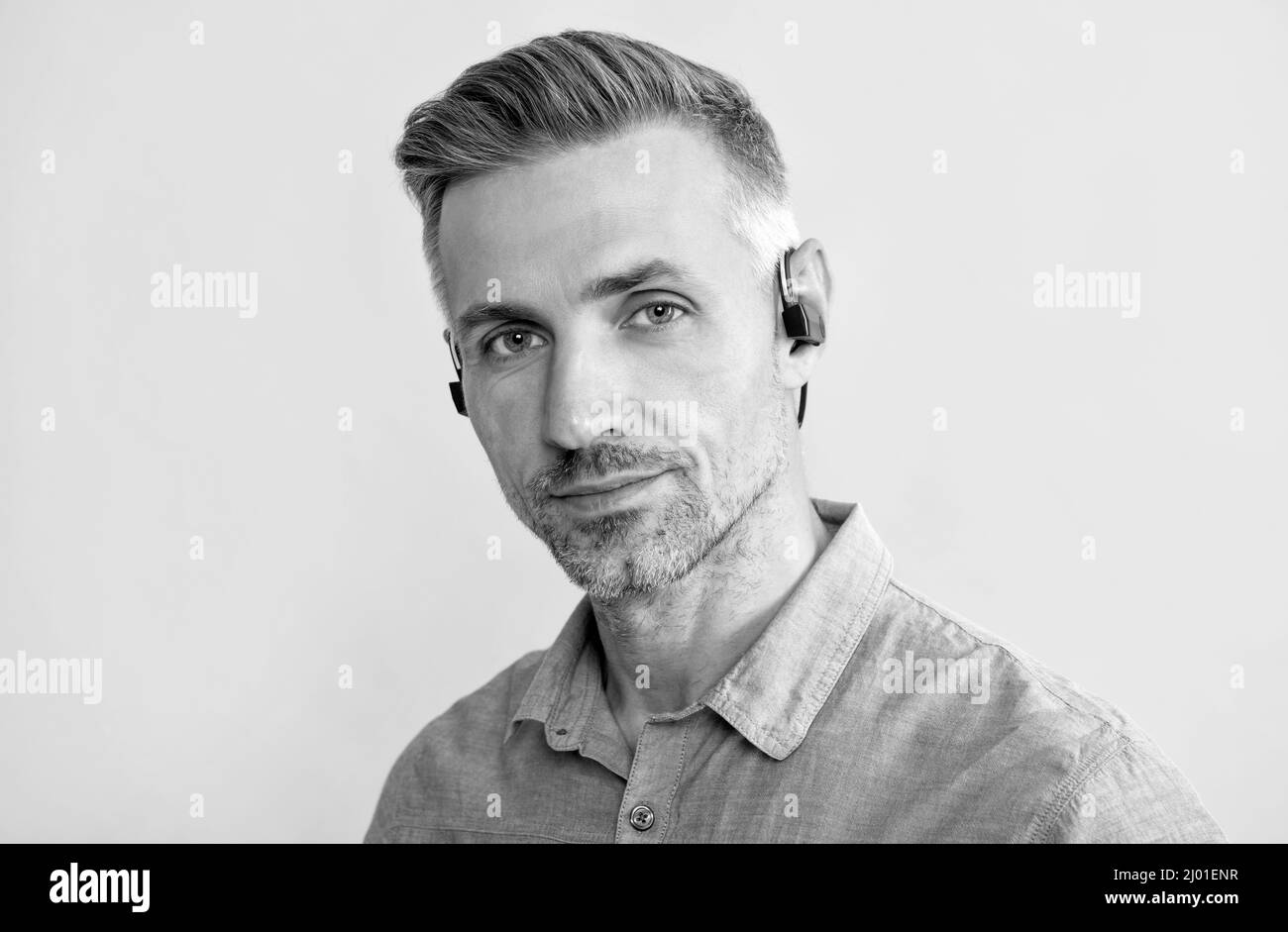 new technology. successful unshaven guy. agile business. handsome man with wireless headphones Stock Photo