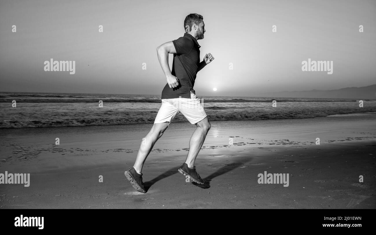 healthy man running on sunrise beach. energetic summer. runner feel freedom. hurry up Stock Photo