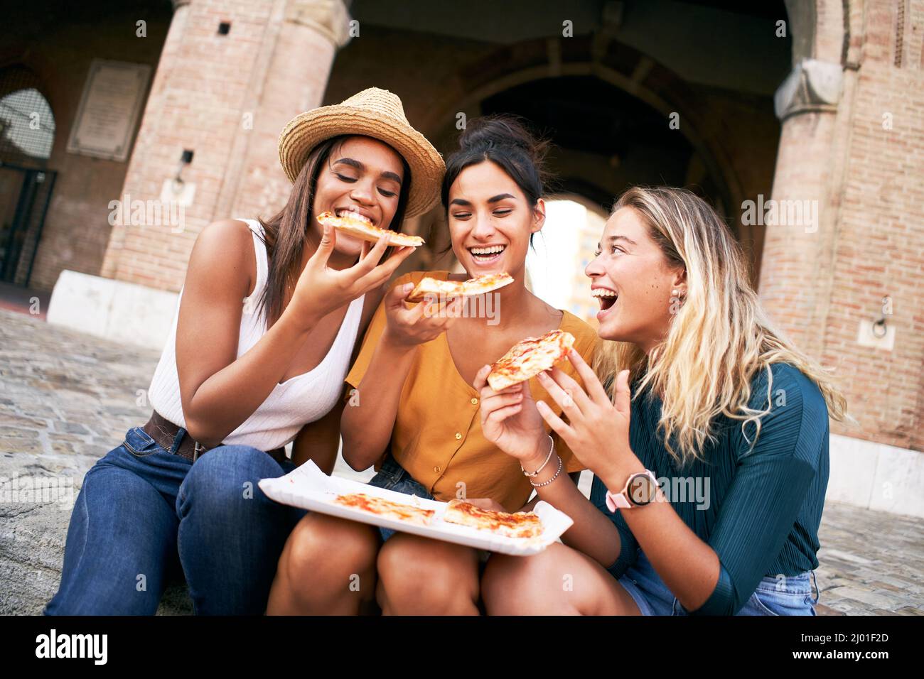 Three Friends Eating Pizza Stock Photo, Picture and Royalty Free Image.  Image 10735477.