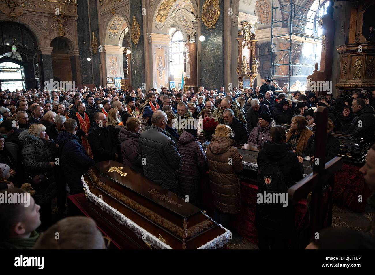 Lviv, Ukraine. 15th Mar, 2022. Civilian mourners attend the funeral service. Three Ukrainian soldiers killed in the March 13th missile attack by Russia at Yavoriv military training ground have been laid to rest. Credit: SOPA Images Limited/Alamy Live News Stock Photo