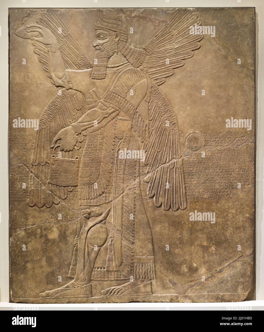 Deity Performing Ritual Purification. Northern Iraq, Nimrud, 9th century B.C.. Sculpture. Gypseous alabaster Stock Photo