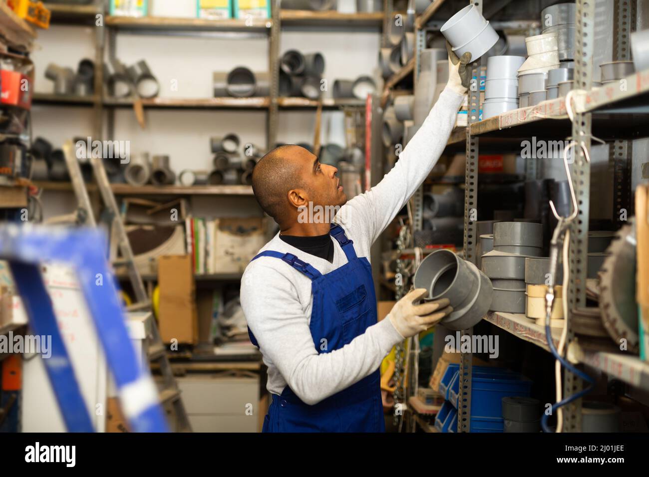 Latin american workman choosing supplies in shop of building materials