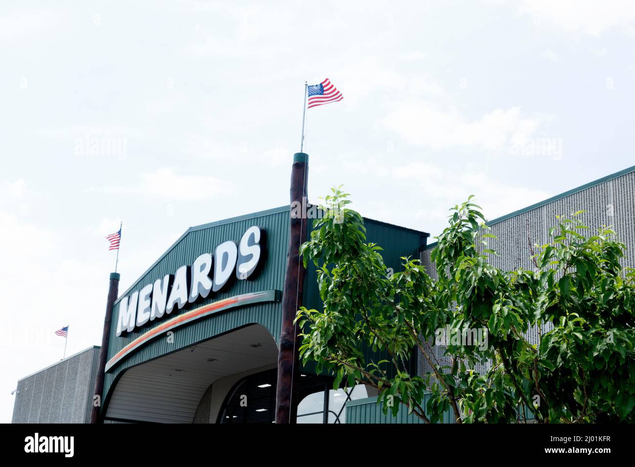 Marquee and arch above entrance to Menards home improvement store with flags flying. St Paul Minnesota MN USA Stock Photo