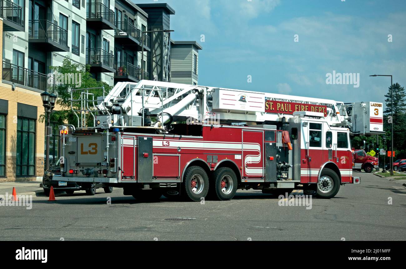 Long St Paul Fire truck blocking a city street during a fire call or emergency. St Paul Minnesota MN USA Stock Photo