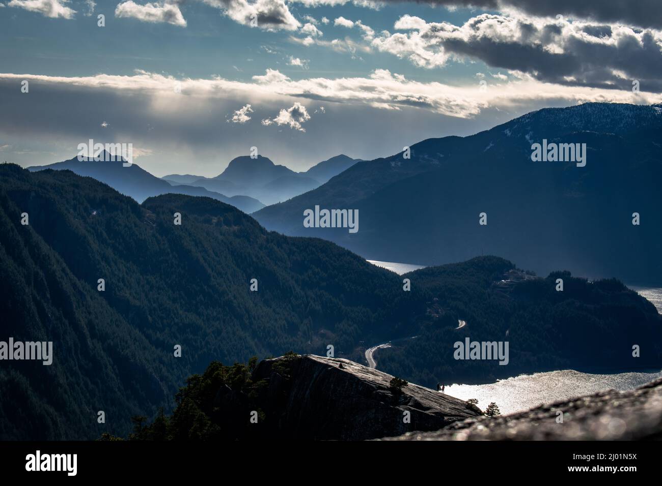 A high-angle perspective overlooking a rolling mountain pass alongside the ocean. Stock Photo